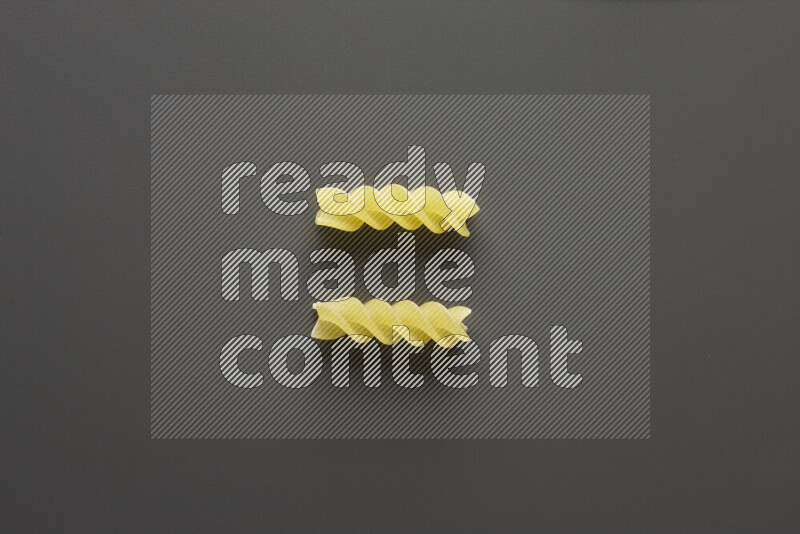 Fusilli pasta on grey background