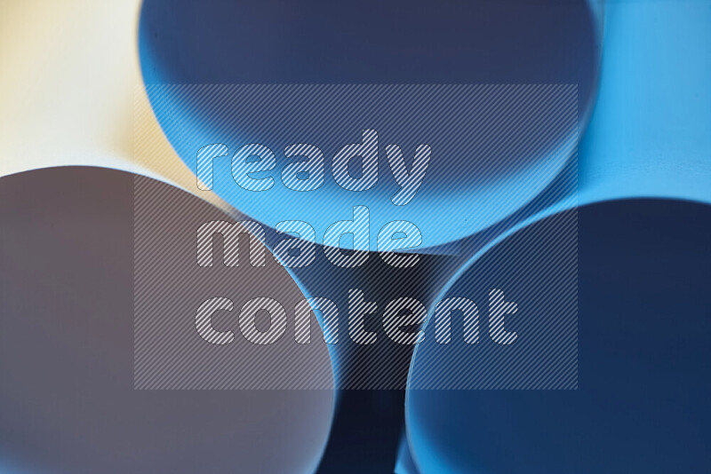 The image shows an abstract paper art with circular shapes in varying shades of blue and warm tones