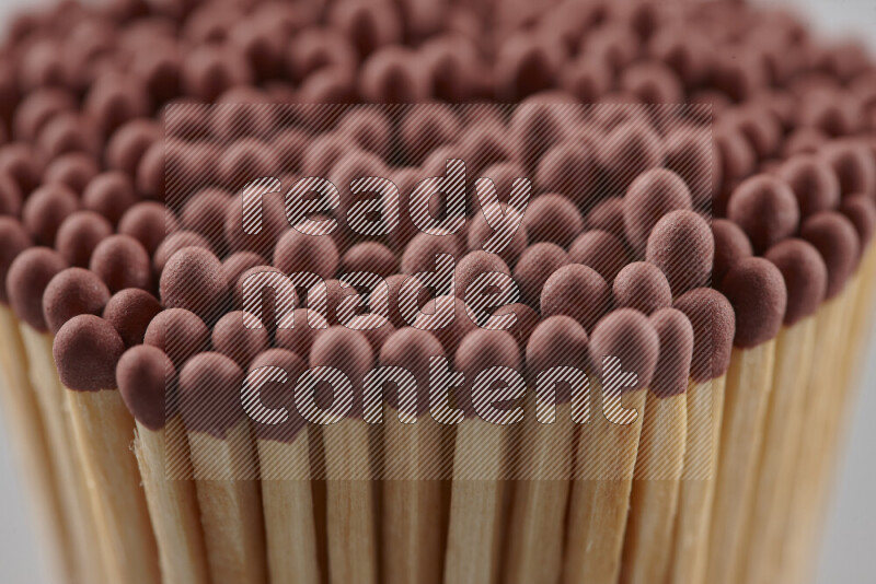 A close-up of a bundle of matches on grey background