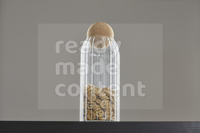 Buttons in a glass jar on black background