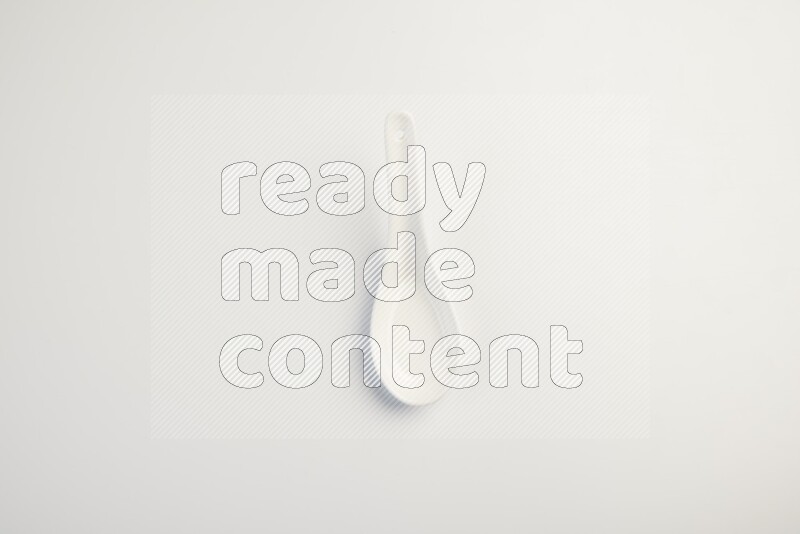 white ceramic soup spoon on white countertop