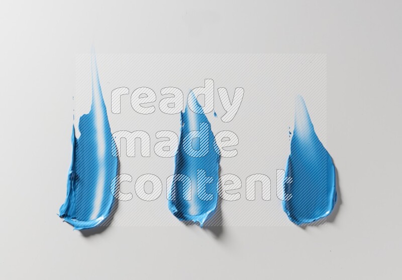 Blue painting knife strokes on white background