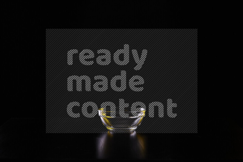 Glassware with rim light in yellow and white against black background