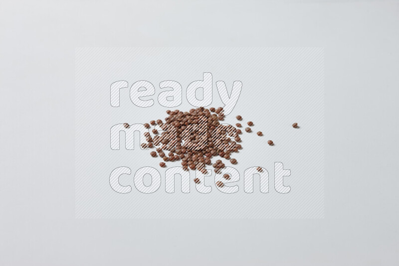 Brown lentils on white background