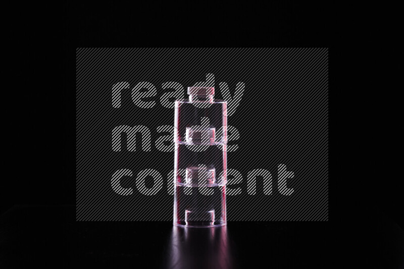 Glassware with rim light in red and white against black background