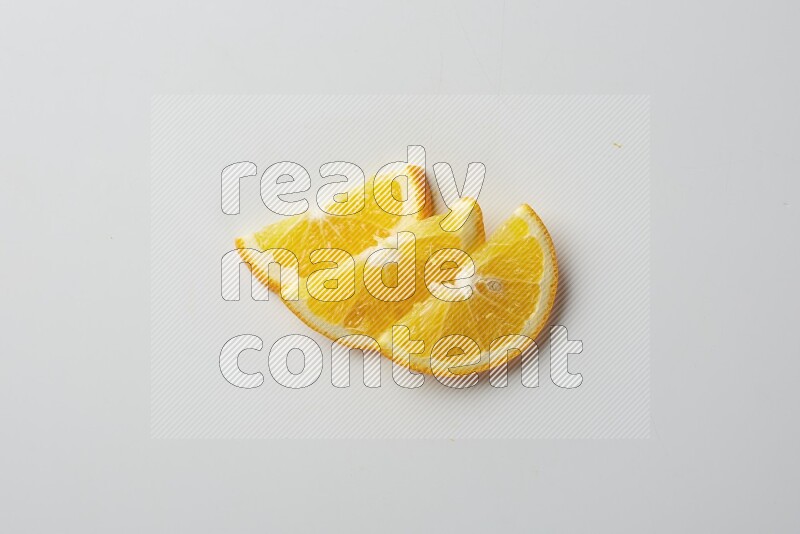 Three halves of an orange slices on white background