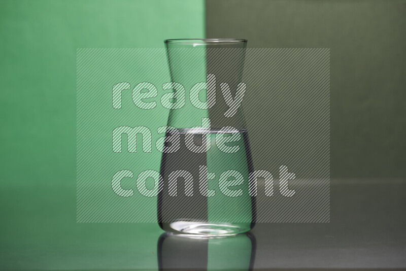 The image features a clear glassware filled with water, set against green and dark green background