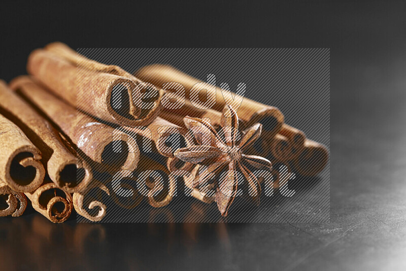 Cinnamon sticks and star anise on black background