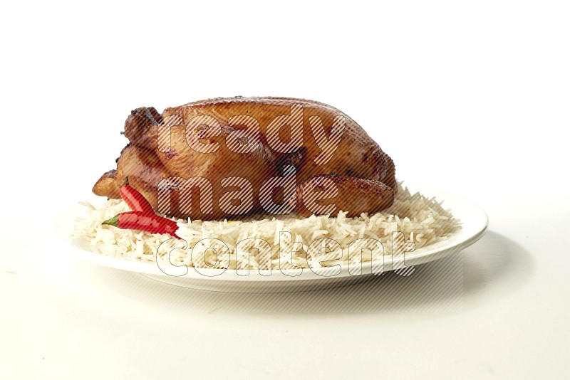 white  basmati Rice with  whole roasted chicken  on a white rounded plate direct on white background