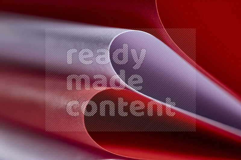 An abstract art showing purple and red paper sheets arranged in an overlapping curves