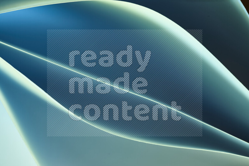 هذه الصورة تعرض تكوين فن الورق التجريدي مع منحنيات ورقية بتدرجات اللون الأخضر والأزرق المكونه بواسطة الضوء الملون