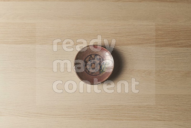 Top View Shot Of A Decorative Pottery Plate on Oak Wooden Flooring