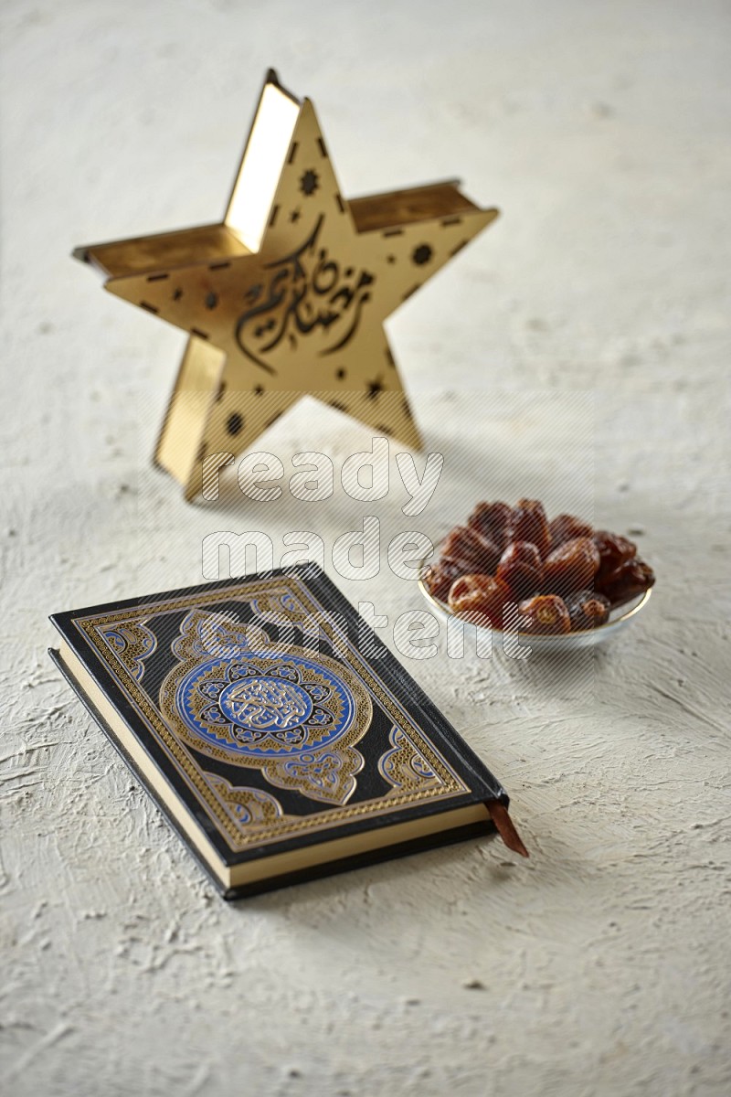 A star lantern with drinks, dates, nuts, prayer beads and quran on textured white background
