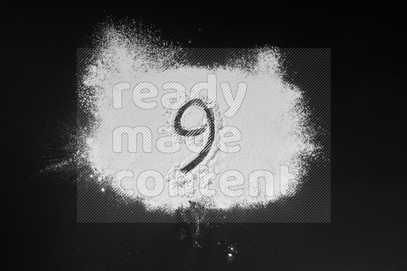 Numbers written with powder on black background