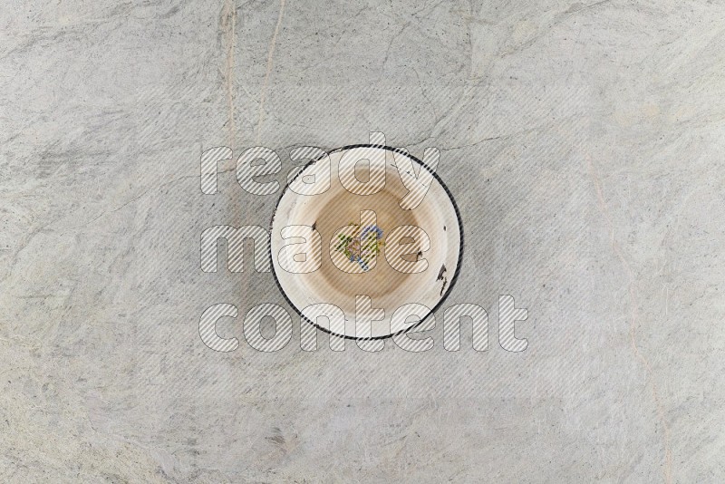 Top View Shot Of A Vintage Metal Plate On Grey Marble Flooring