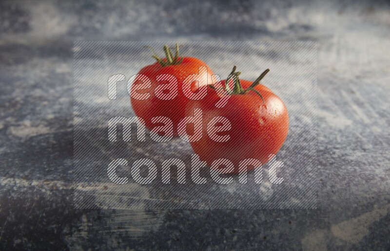 45 degree roma tomato on a textured rustic blue background