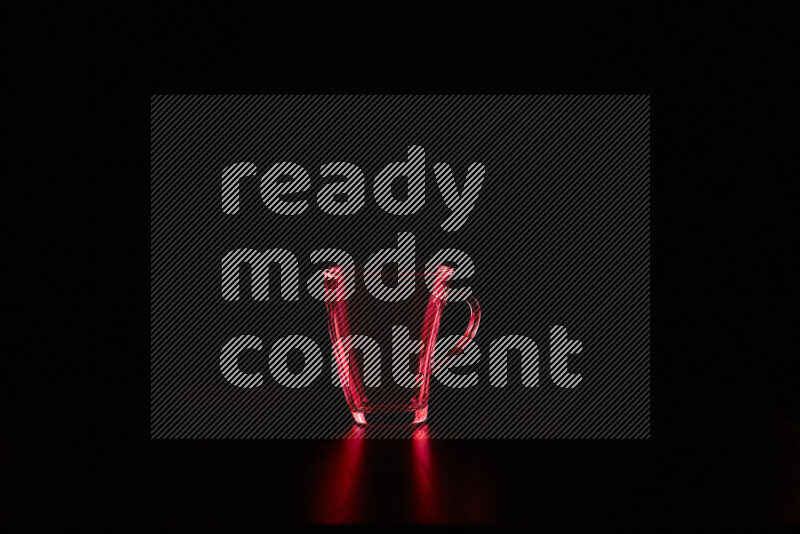 Glassware with rim light in red against black background