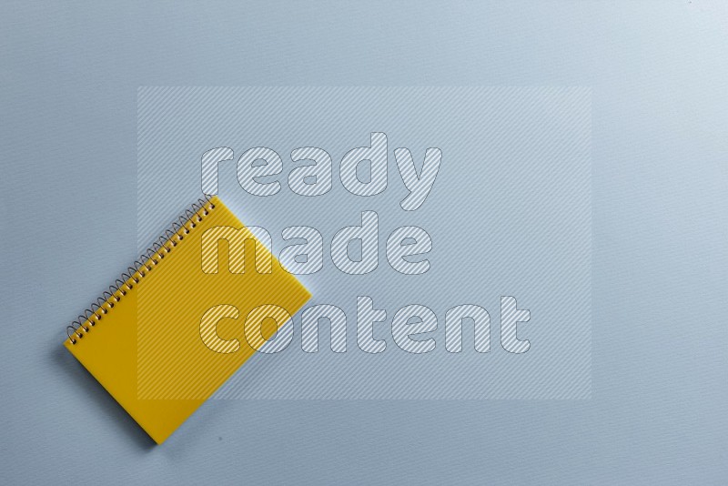 A yellow notebook on blue background (Back to school)