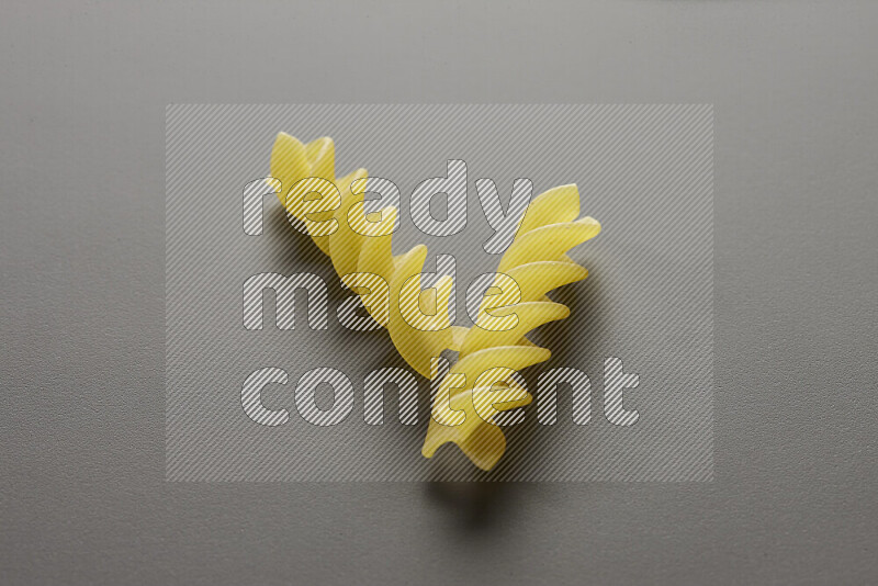 Fusilli pasta on grey background