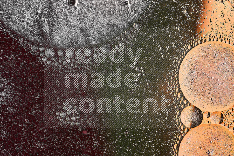 لقطات مقربة لفقاعات من الزيت على سطح الماء باللون البرتقالي والأخضر والأحمر