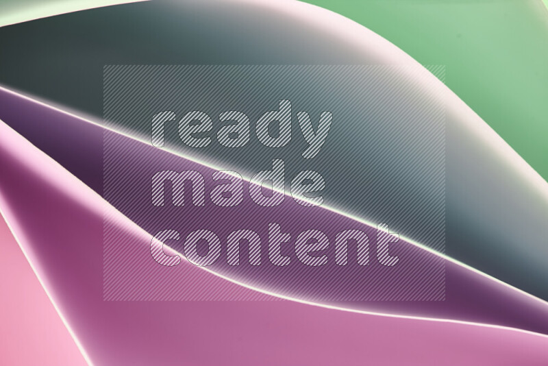 This image showcases an abstract paper art composition with paper curves in green and pink gradients created by colored light