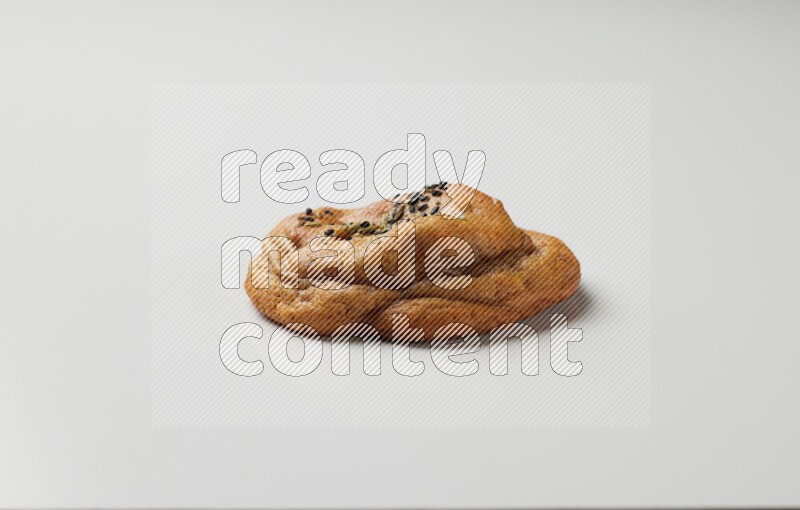 Hasawi cookie field with date and decorated by black seed and Anise grain on a white background