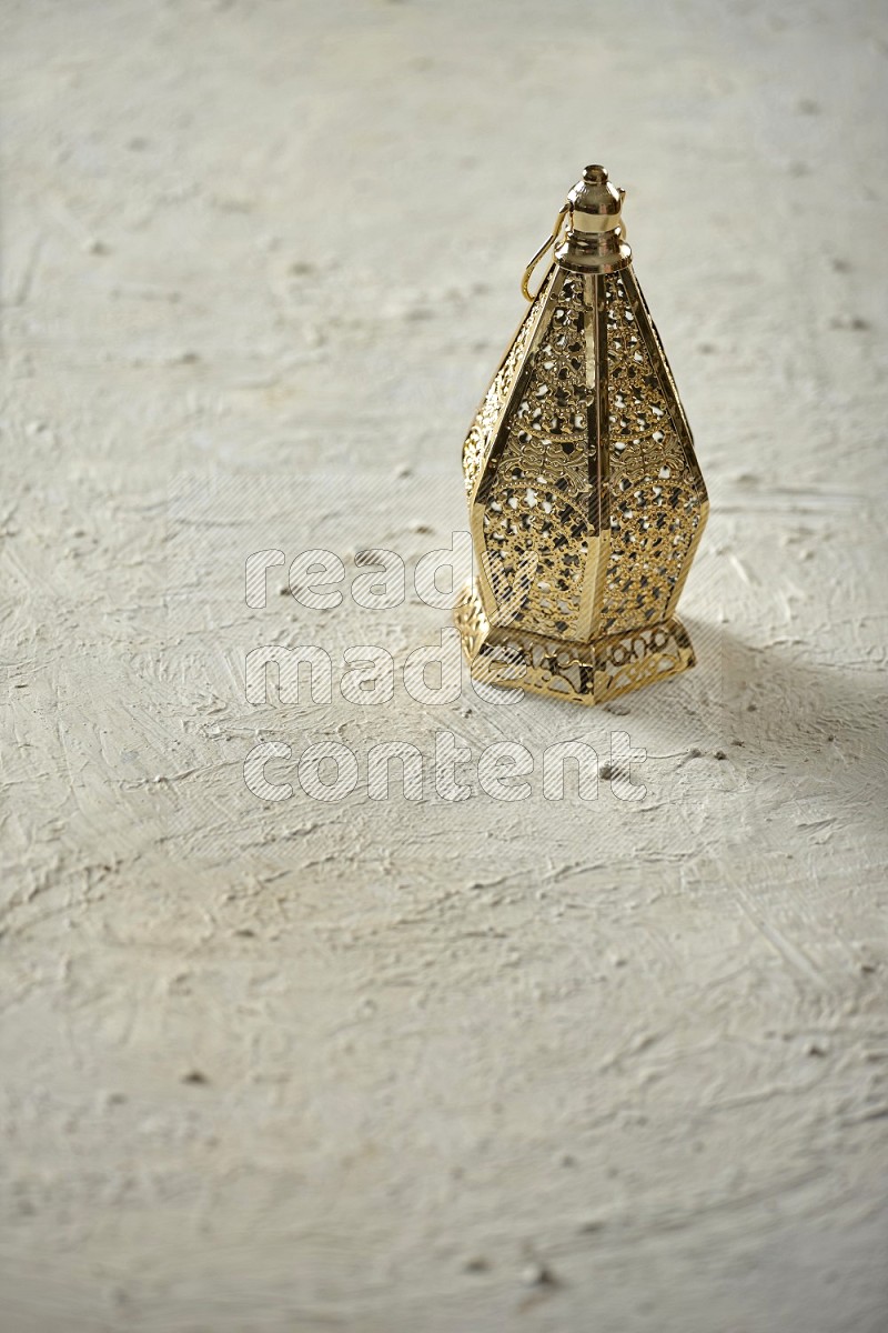 A lantern placed on a textured white background