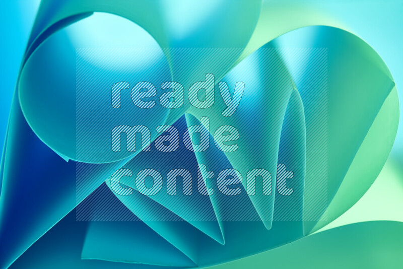 An artistic display of paper folds creating a harmonious blend of geometric shapes, highlighted by soft lighting in green and blue tones