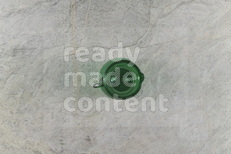 Top View Shot Of An Empty Glass Jug On Grey Marble Flooring