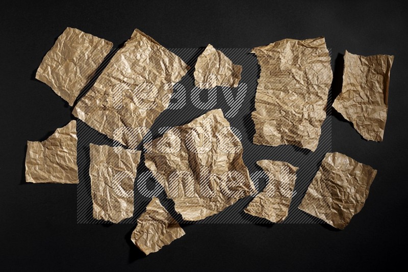 Crumpled craft paper on black background