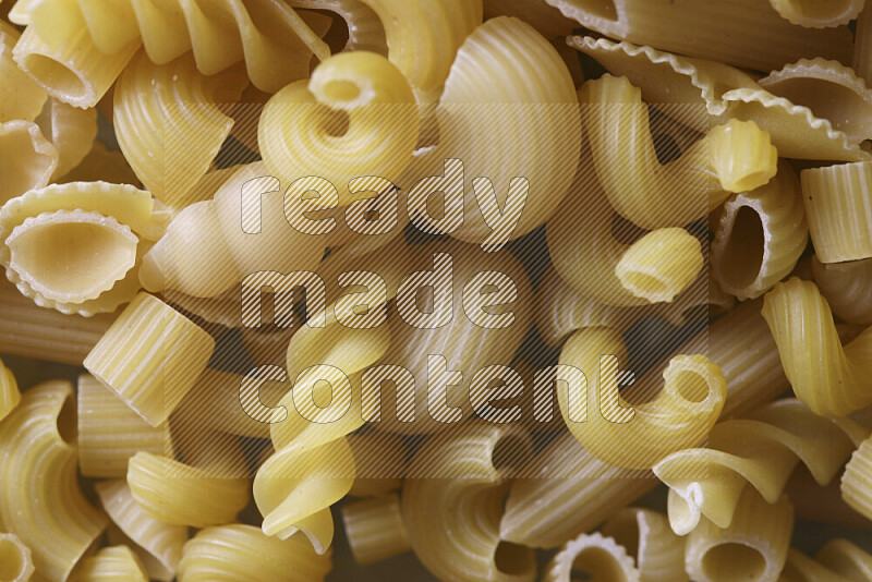 Different pasta types on light blue background