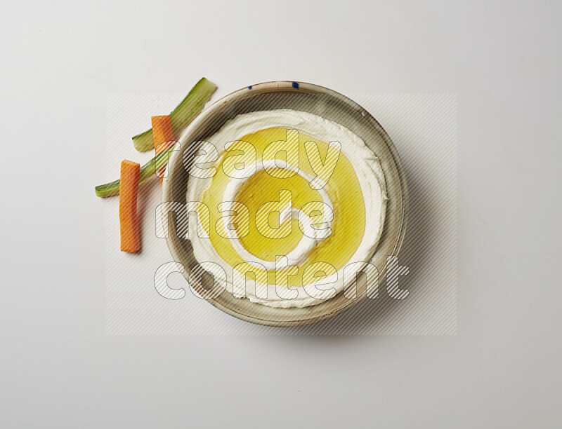 Lebnah garnished with olive oil in a grey pottery plate on a white background