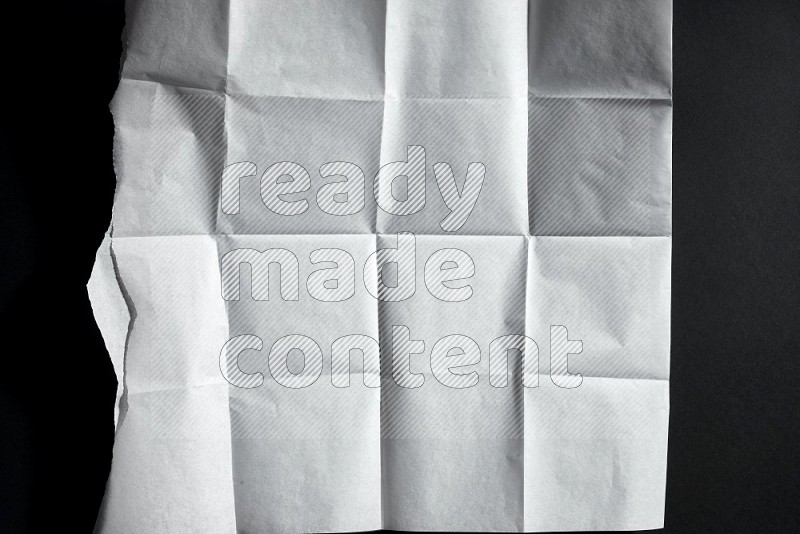 White paper sheet on black background