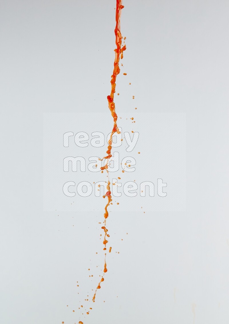 Orange liquid splash and drops on white background