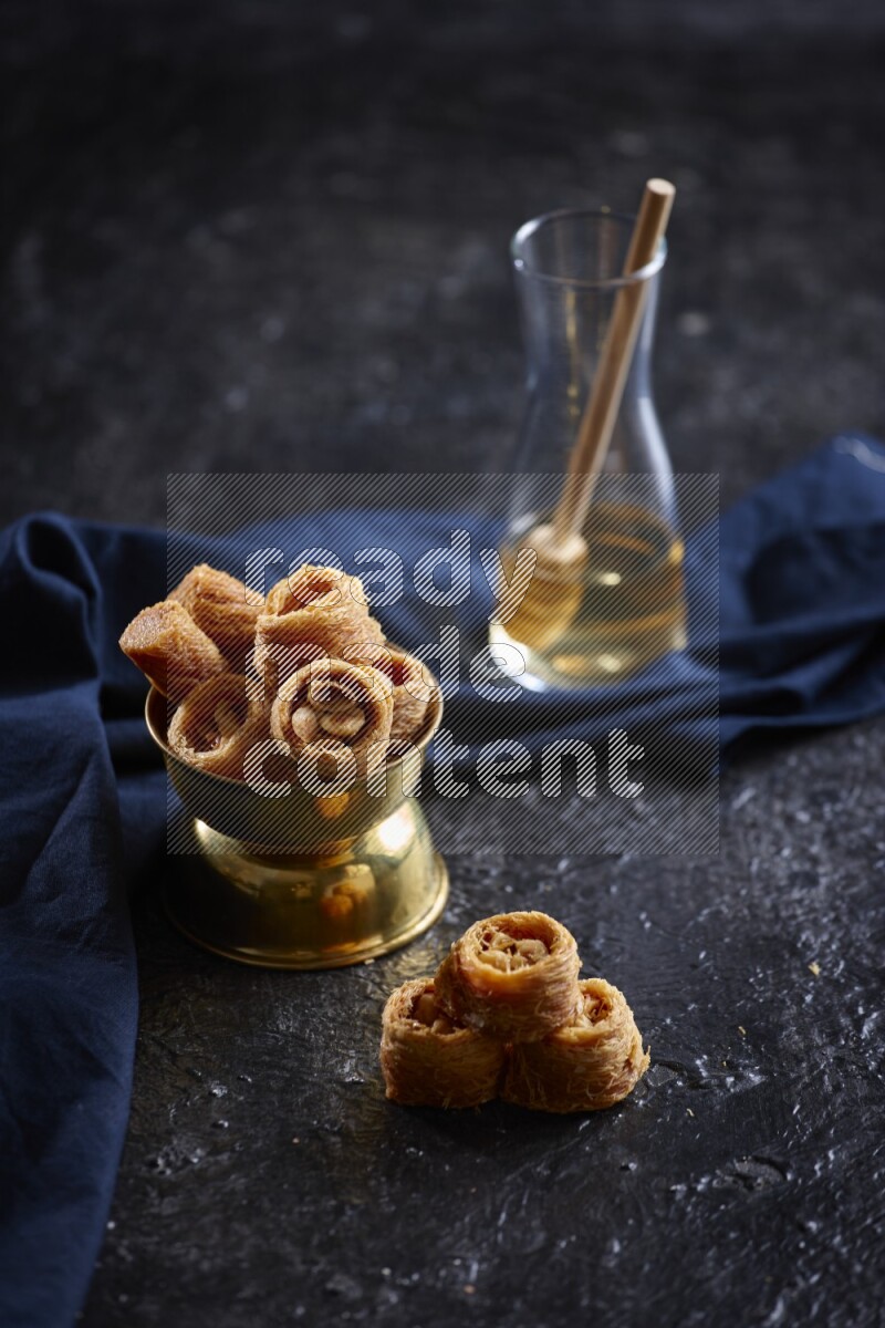 konafa in a metal bowl in a dark setup