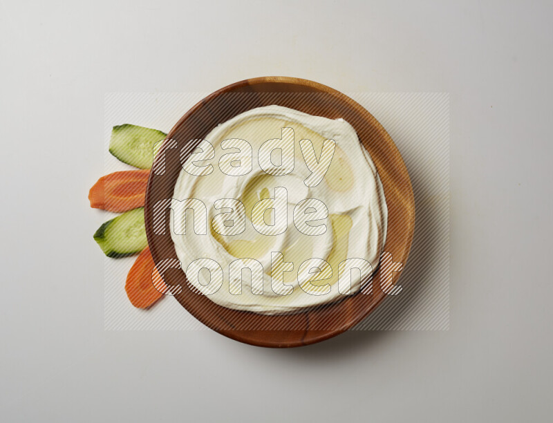 Lebnah garnished with olive oil in a wooden plate on a white background