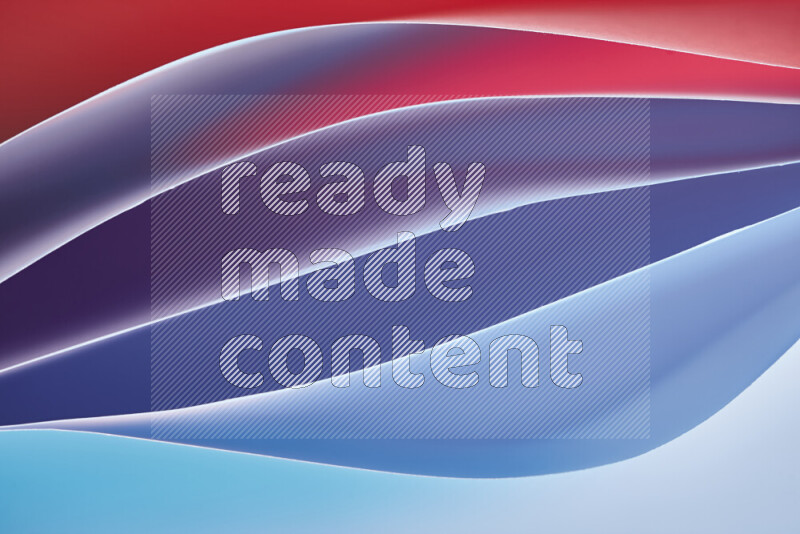 هذه الصورة تعرض تكوين فن الورق التجريدي مع منحنيات ورقية بتدرجات اللون الأزرق والأحمر المكونه بواسطة الضوء الملون