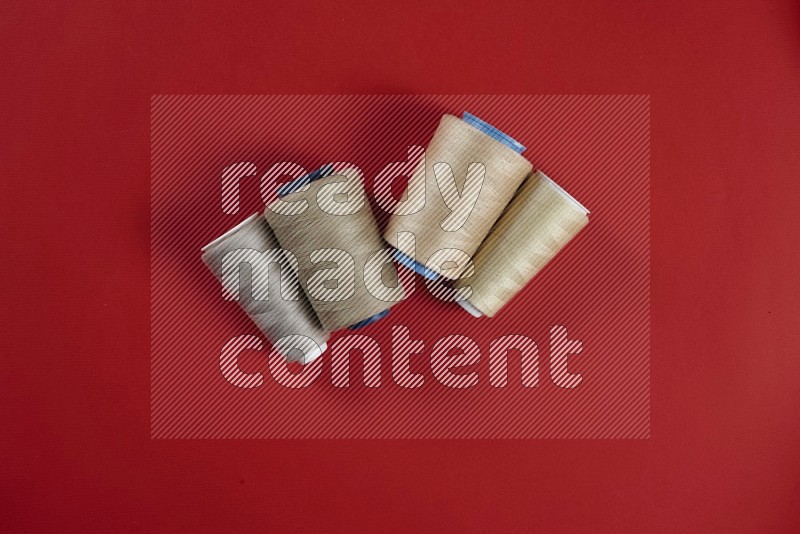 Brown sewing supplies on red background
