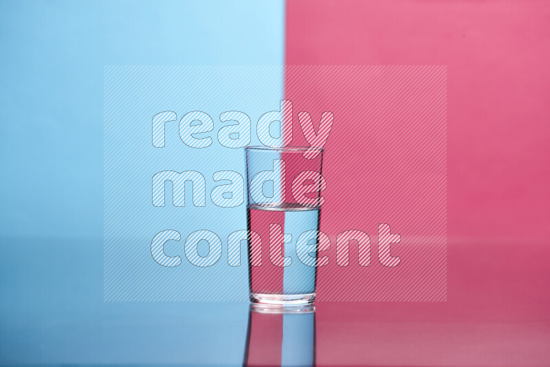 The image features a clear glassware filled with water, set against light blue and pink background