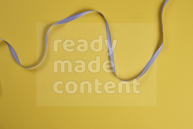 A purple collection of sewing and tailoring tools arranged on a yellow background