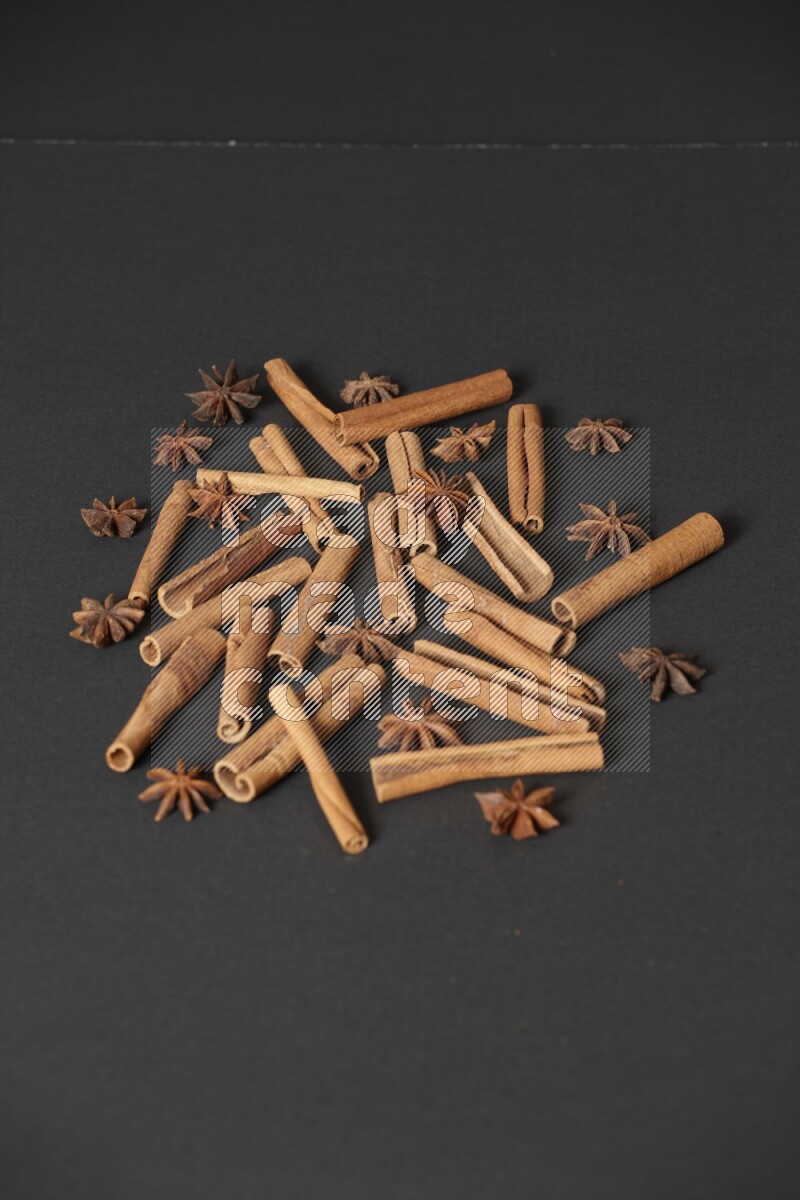 Cinnamon sticks and star anise on black background