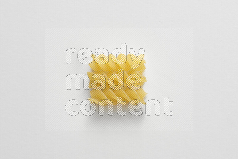 Fusilli pasta on white background