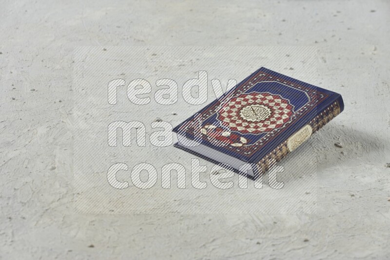 Quran with a prayer beads on white background