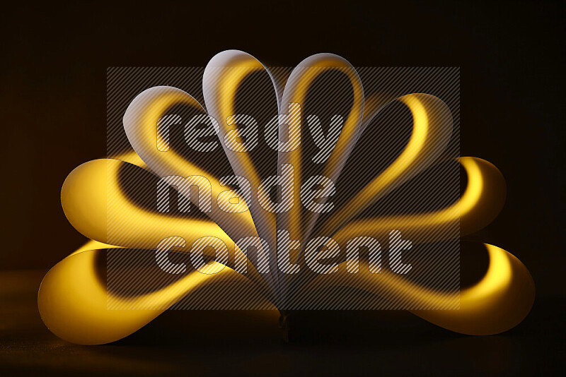An abstract art piece displaying smooth curves in yellow gradients created by colored light