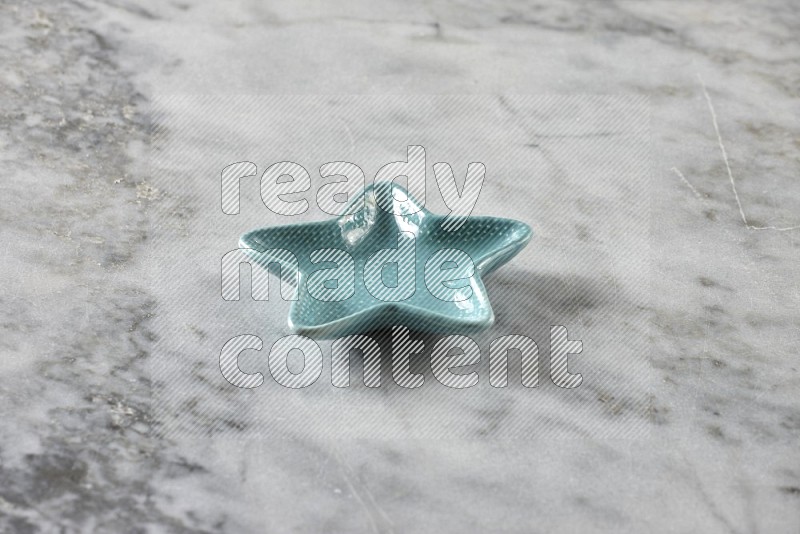 A pottery star plate on grey marble background