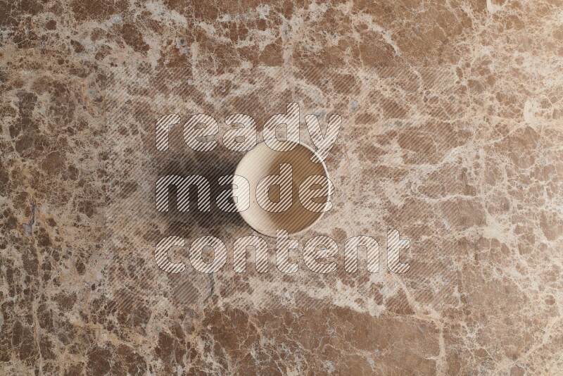 A white pottery bowl on beige marble background