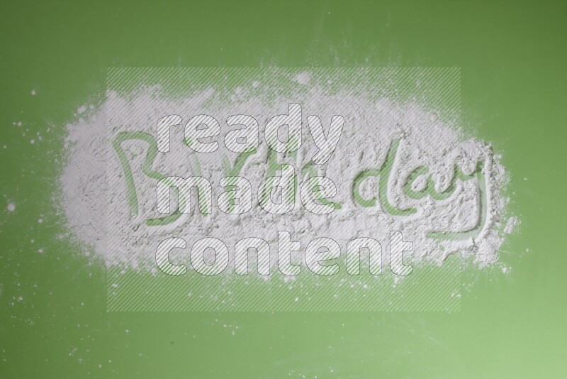 A word written with powder on green background