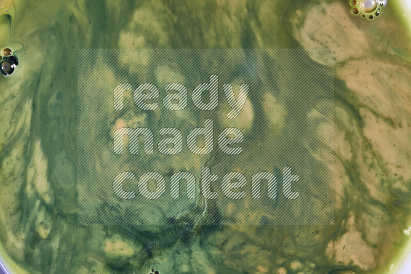 A close-up of abstract swirling patterns in orange and green