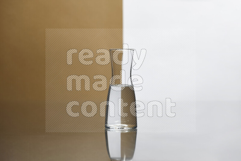 The image features a clear glassware filled with water, set against white and beige background