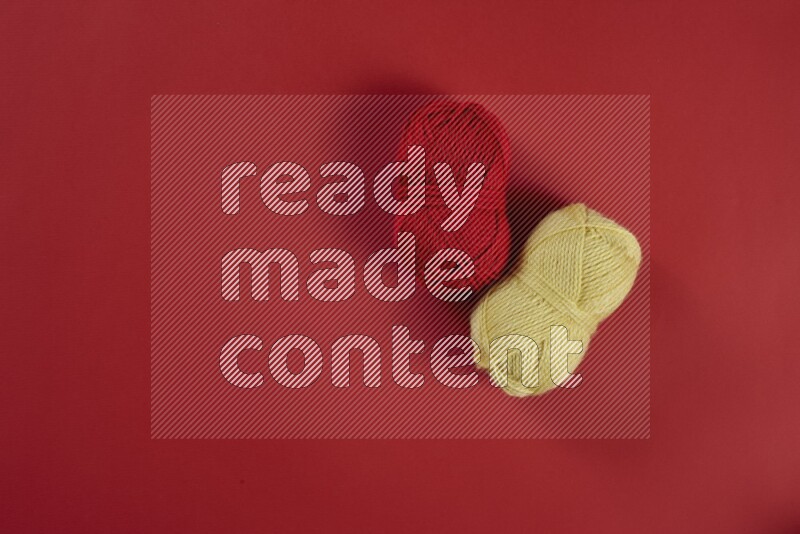 A yellow collection of sewing and tailoring tools arranged on a red background